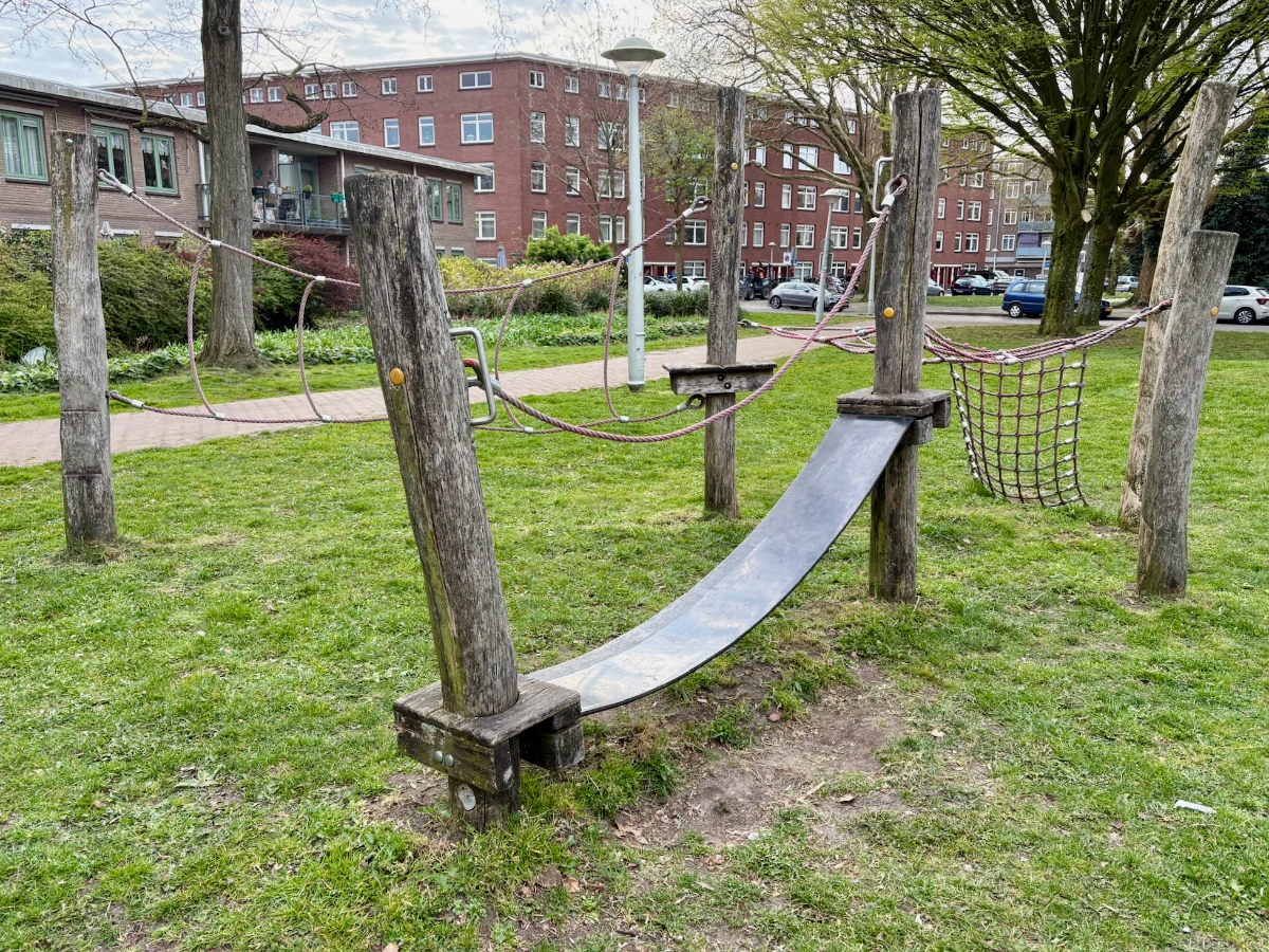 Obstacle course on grassy lawn with ropes and nets