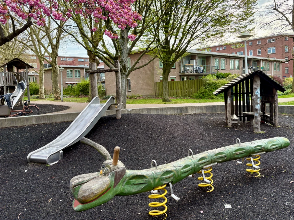 Green wooden caterpillar rocker and small slides and wooden play house