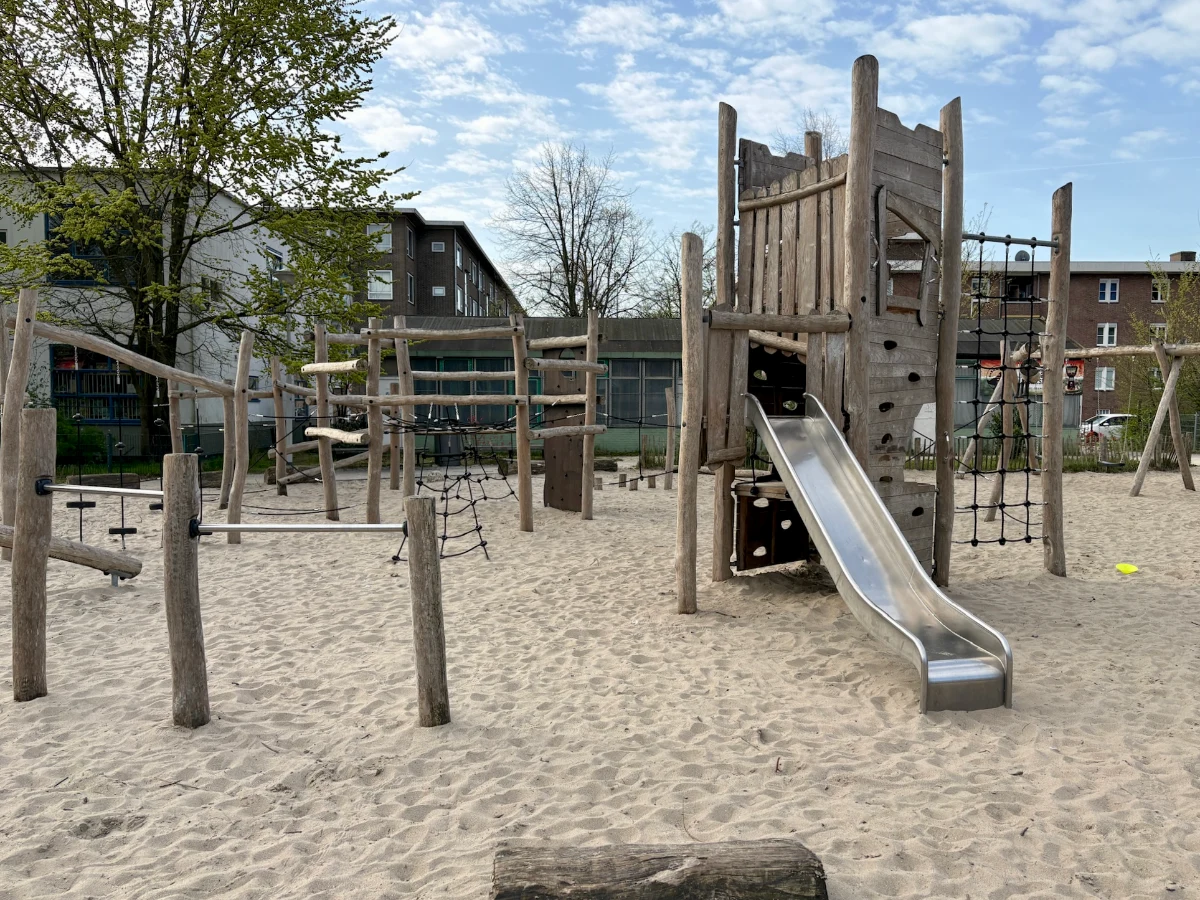 Wooden climbing obstacle course with ropes and slide