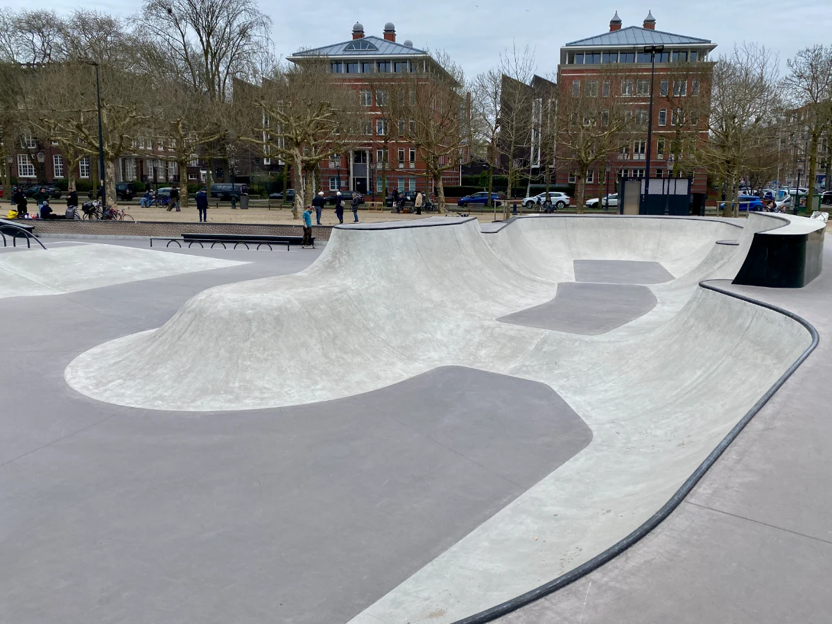 Skatepark with bowl and ramps set within urban area