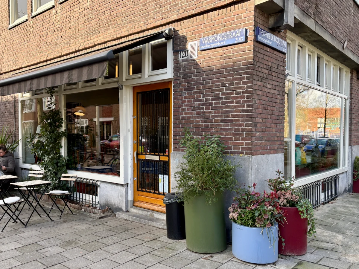 Entrance to coffee shop with a few tables outside
