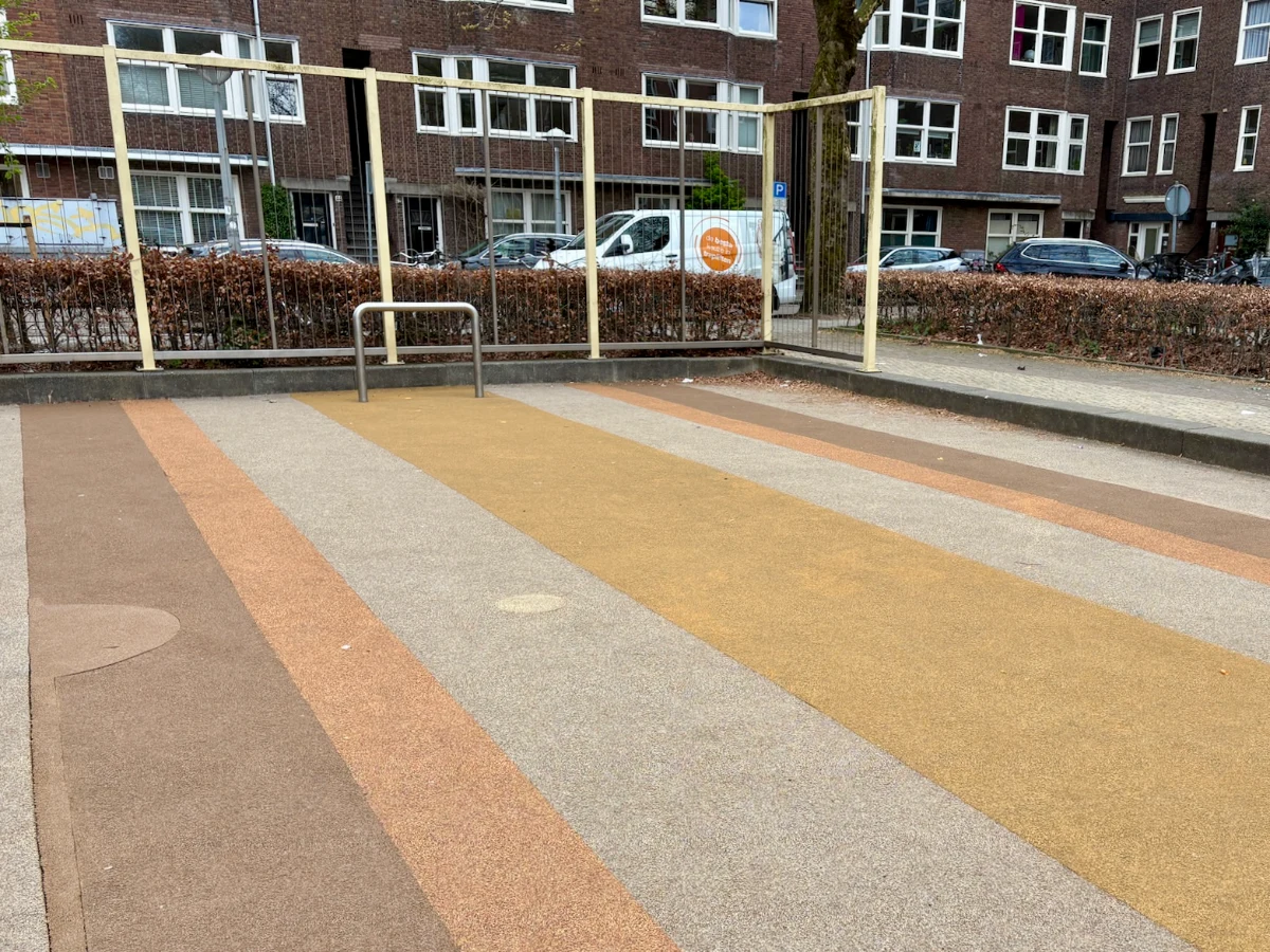 Yellow, grey, and orange striped mini football pitch with yellow metal enclosure